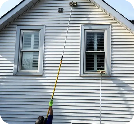 home3 Window cleaners cleaning second story windows with a long cleaning pole in Dallas-Fort Worth